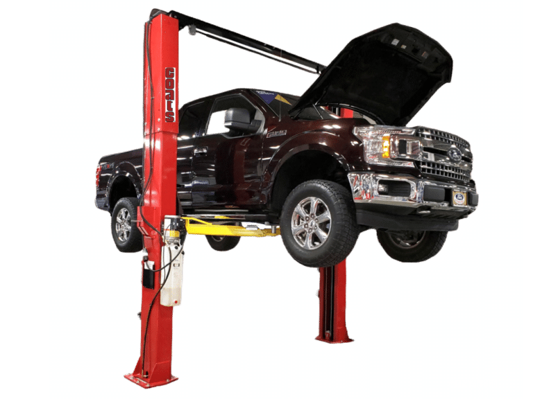 A black Ford truck with its hood opened is lifted on a Coats 12K two post lift.