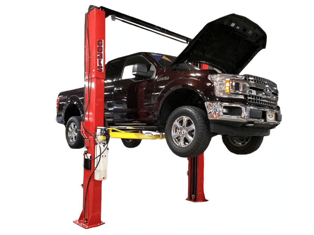 A black Ford truck with its hood opened is lifted on a Coats 12K two post lift.