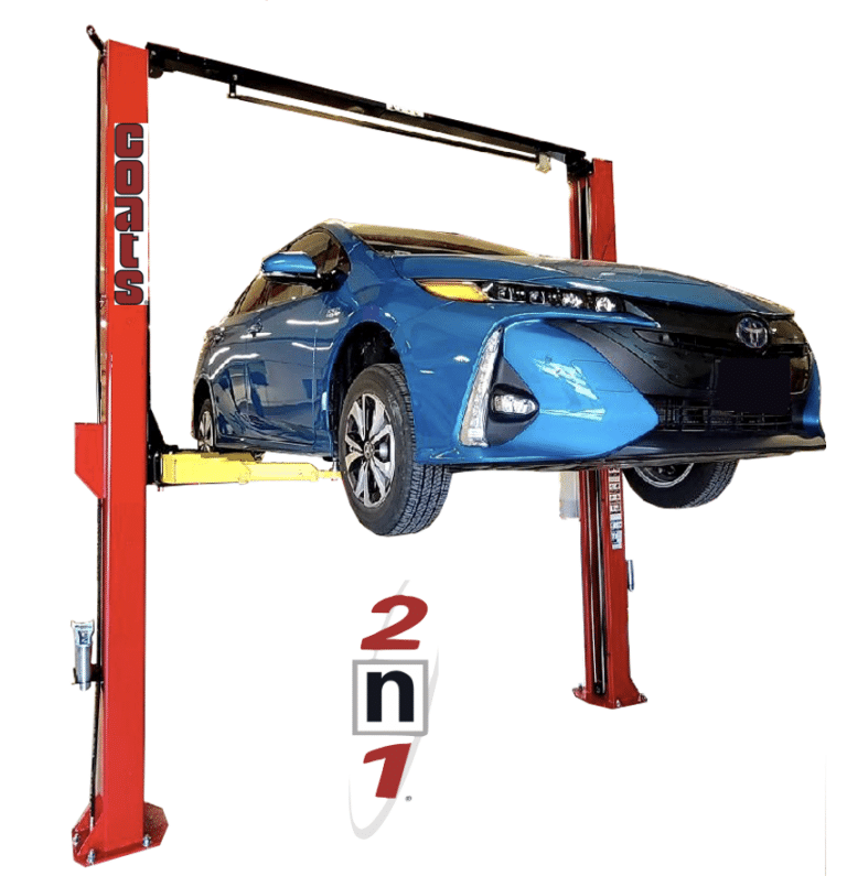 A blue Toyota sedan is raised on a red, Coats 10K 2N1 two post lift with yellow arms