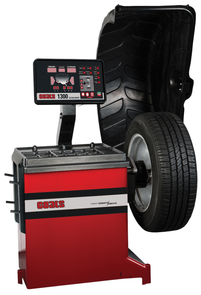 Coats 1300 wheel balancer, red and black machine with a tire ready for balancing.D