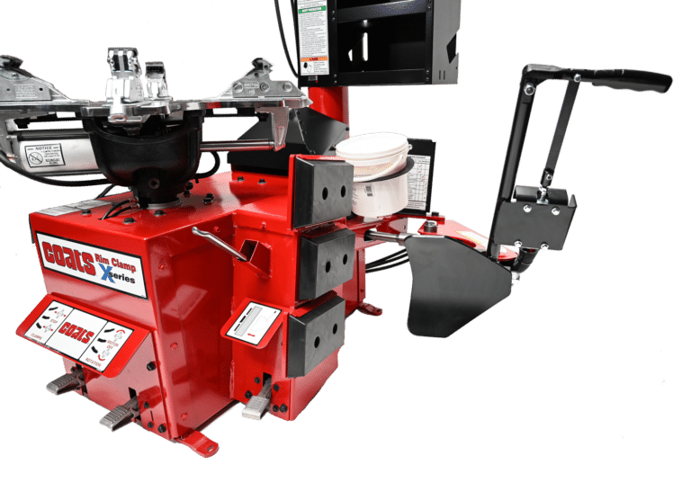 The red chassis of the tire changer with a black shovel shaped bead loosener