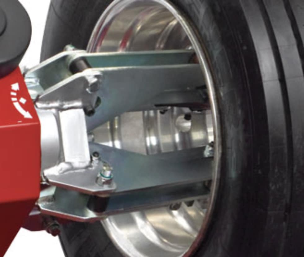The four jaw steel jaw clamps onto the inside of a wheel that is mounted on the COATS CHD heavy duty tire changer