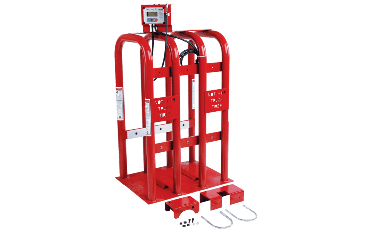 Tall, red, cage like structure with air hoses and an air pressure monitor