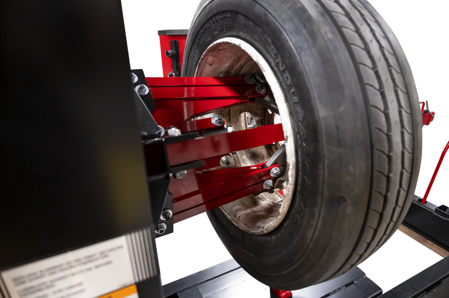 A close up of the hydraulic clamping chuck holding a tire in place on a heavy duty tire changer