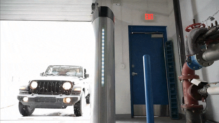 A gif of a Jeep Wrangler entering a garage and driving through the Coats Inspection Lane System