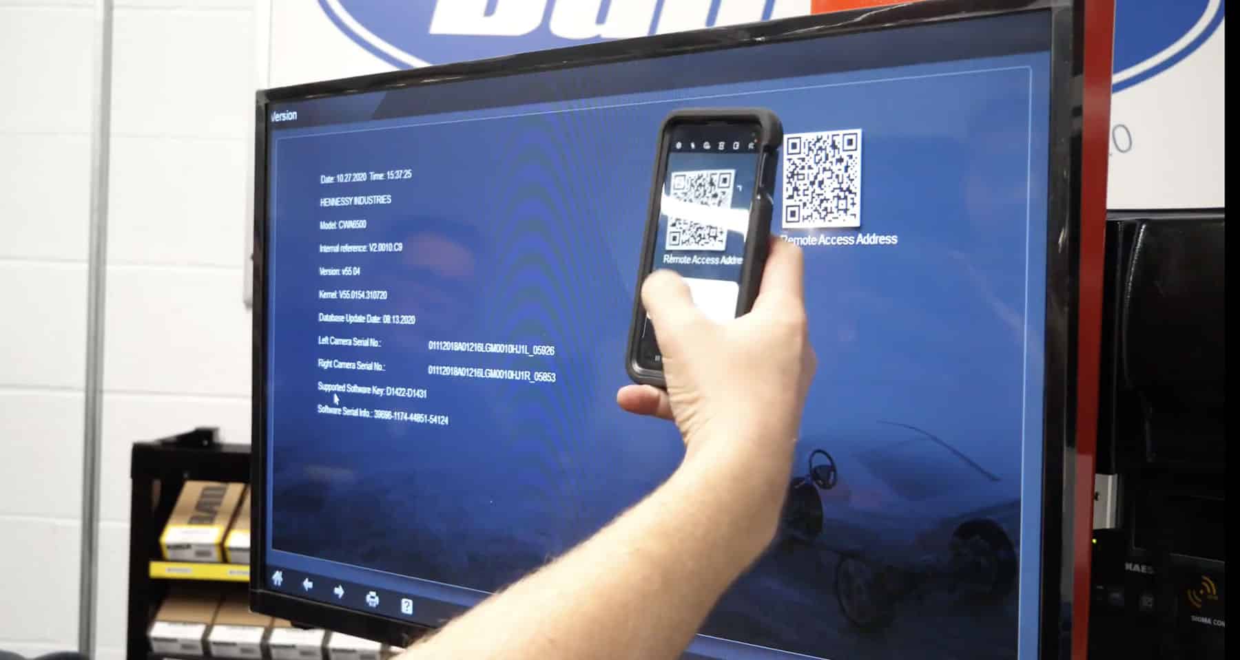 A technician uses his mobile phone camera to scan the QR code on the aligner’s desktop monitor