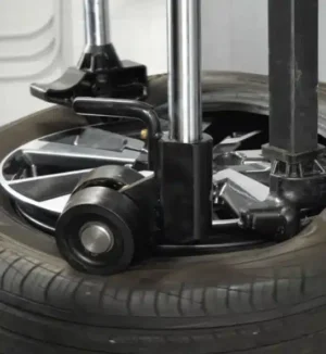 RoboRoller pressing against the tire to hold the tire bead in place on a tire changer