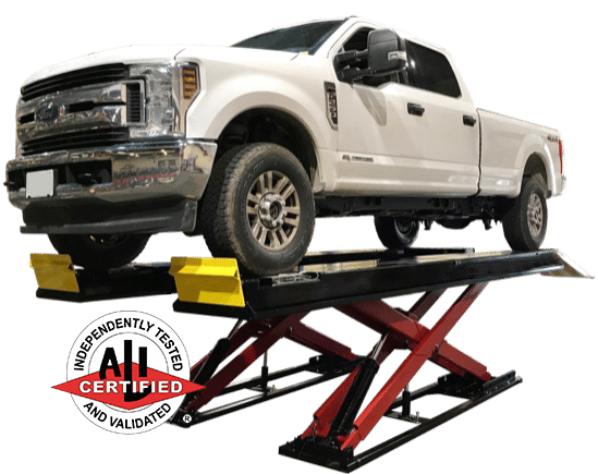 A heavy duty white truck sits on a raised scissor lift with black runways. An ALI Certification logo is in the lower left corner