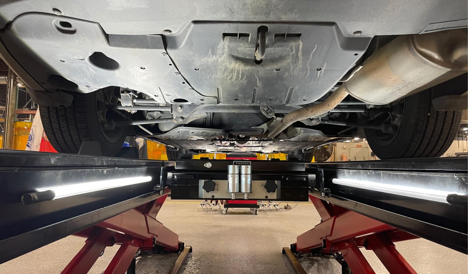 LED tub lighting lines the inside length of the lift runways to illuminate the underside of the car that is on the alignment lift