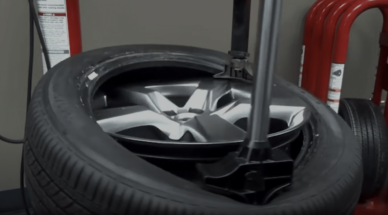 Youtube video clip showing the texas-shaped roboarm helper device resealing the tire onto the wheel assembly.