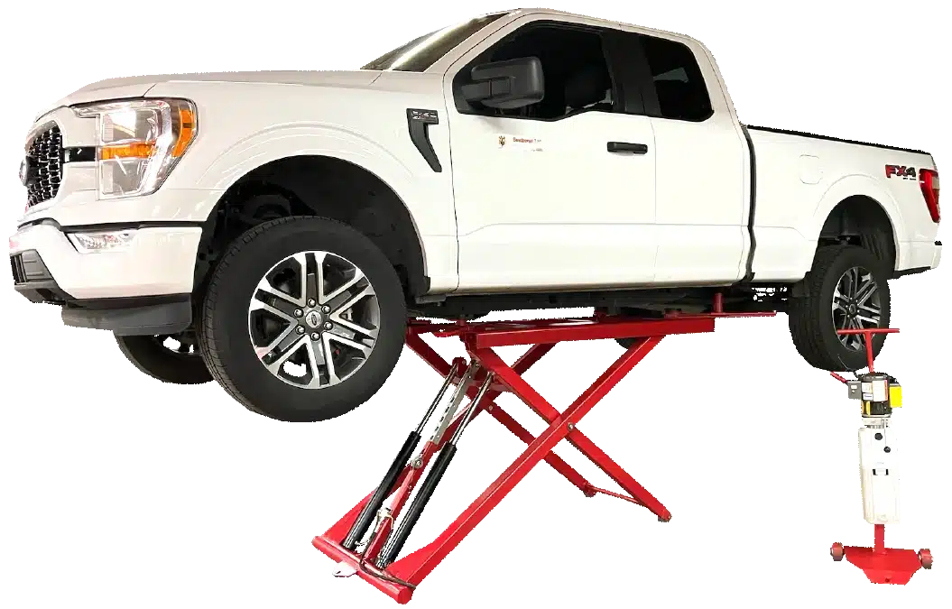 A white, light duty truck is raised on a red, Coats 6K Mid Rise Portable Scissor Lift