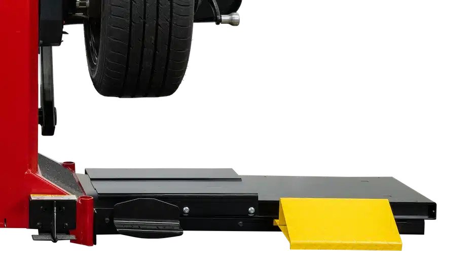 black and yellow Coats 525 wheel balancer lift attached to a Coats wheel balancer